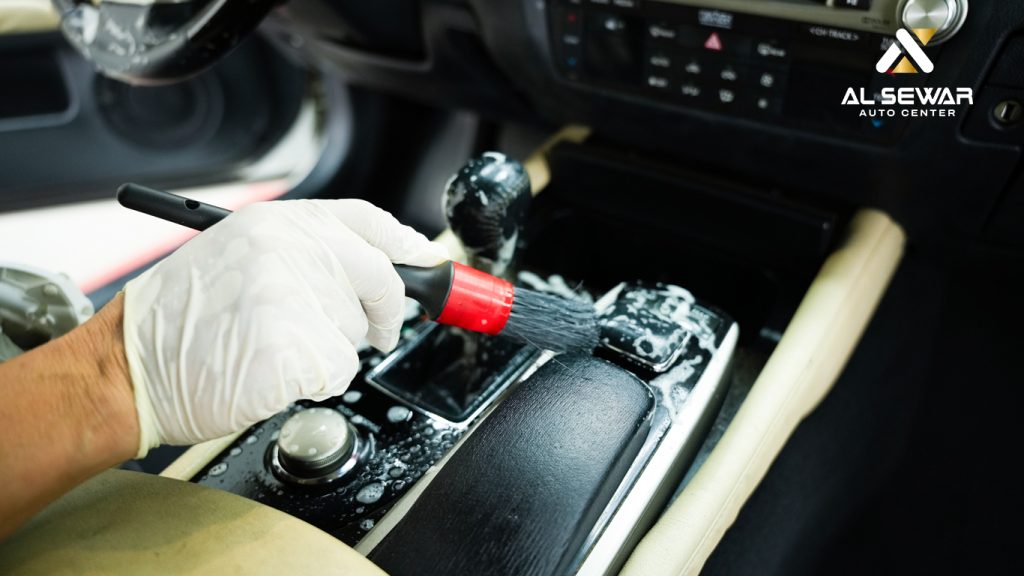 A professional mechanic checks the engine of a car in a workshop, highlighting essential summer car maintenance such as coolant checks, battery inspection, and air conditioning service.