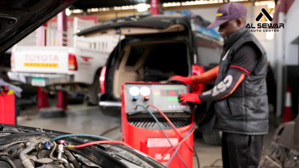 Mechanic checking car air conditioning system in a professional UAE auto service center, ensuring optimal cooling performance during summer.