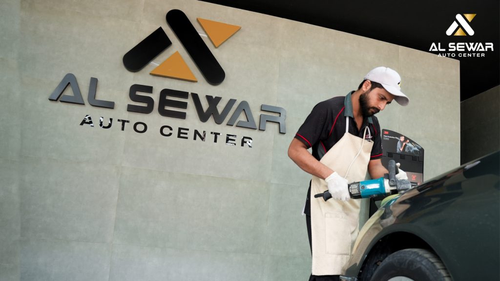 Car owner polishing a sleek, shiny car using a dual-action polisher, demonstrating a professional car detailing process