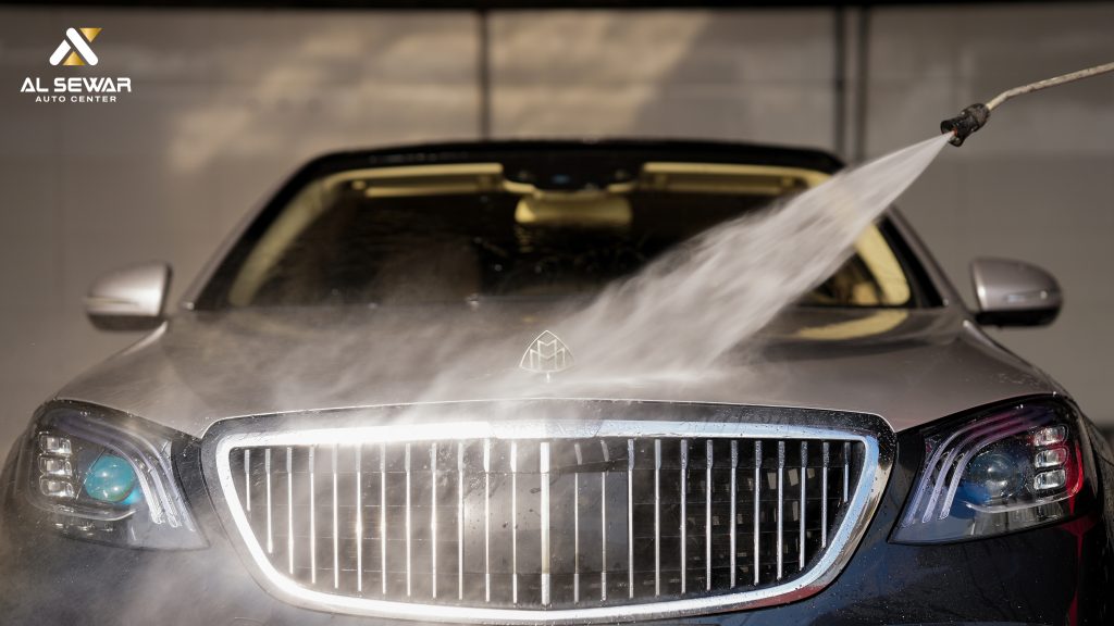 Luxury Maybach sedan undergoing professional high-pressure car wash at Al Sewar Auto Center.