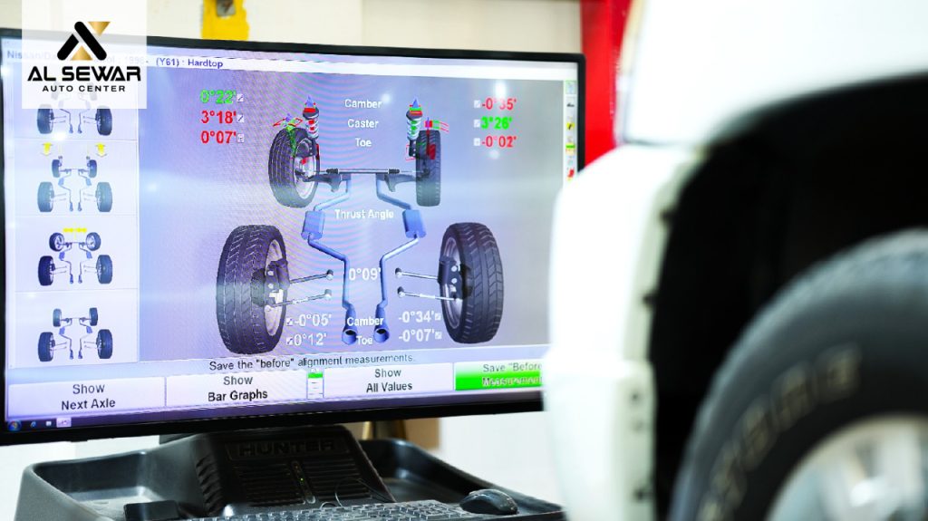 Computerized wheel alignment screen displaying camber, caster, toe, and thrust angle measurements during a vehicle alignment service at Al Sewar Auto Center.